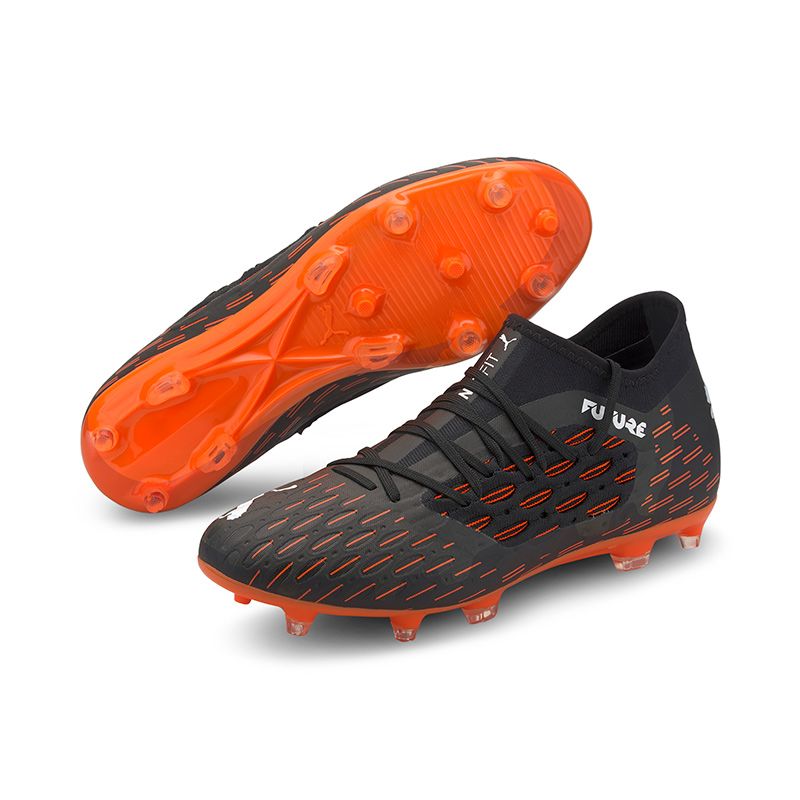 white and orange football boots