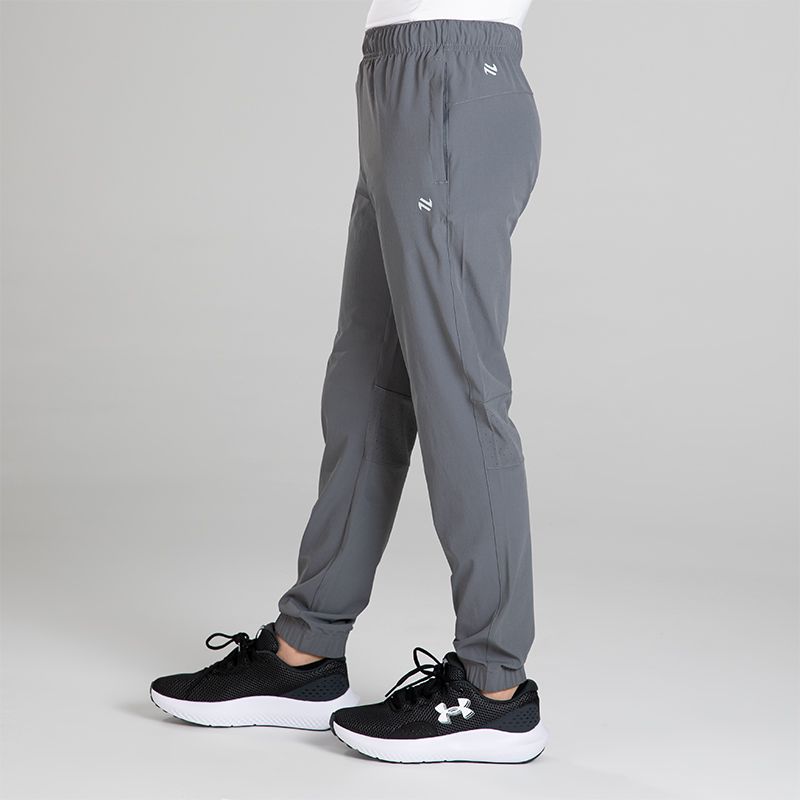 Grey Kids’ Horizon Woven Tracksuit bottoms with two zip pockets by O’Neills.