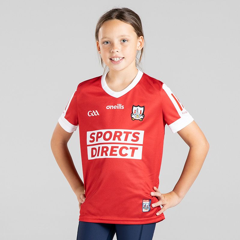 Red/White kids' Cork GAA Home Jersey with sponsor logos by O'Neills.