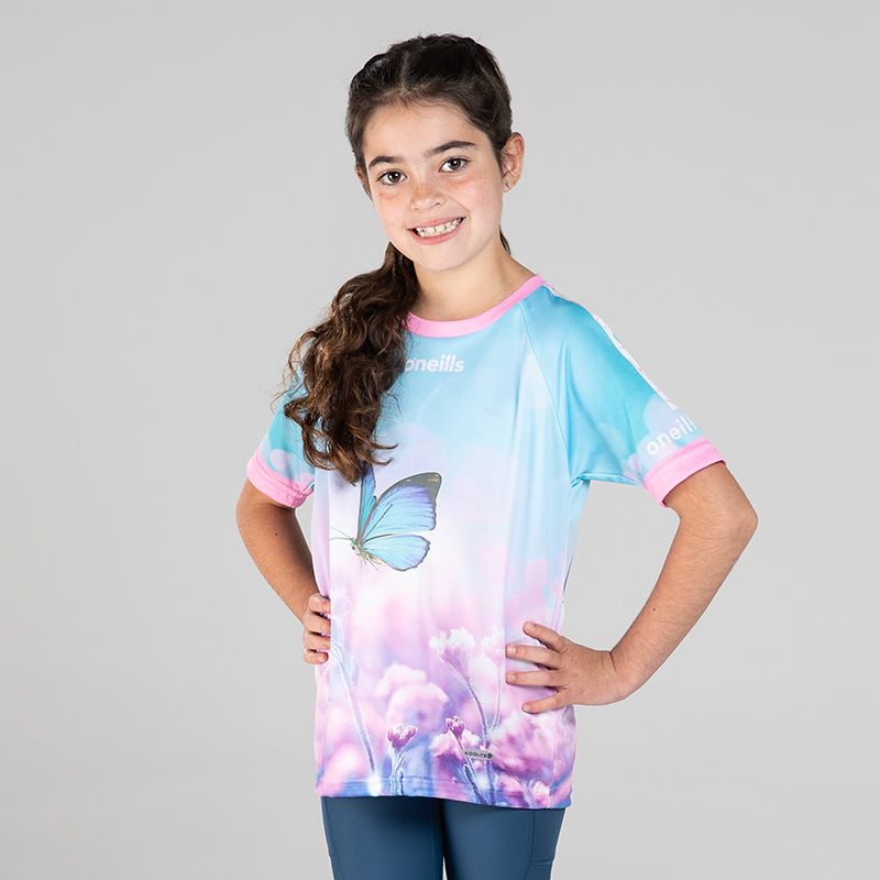 Pink Kids’ Flutter By O’Neills ploughing jersey with image of a butterfly on the front.