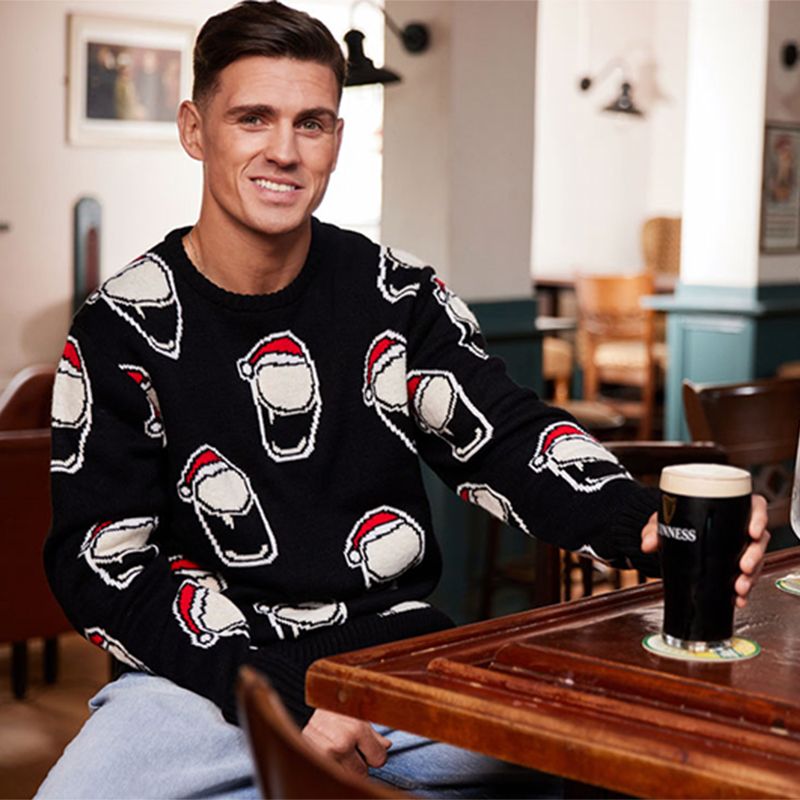 Black white and red Guinness Christmas Allover Smiley Pint Sweatshirt from O'Neills