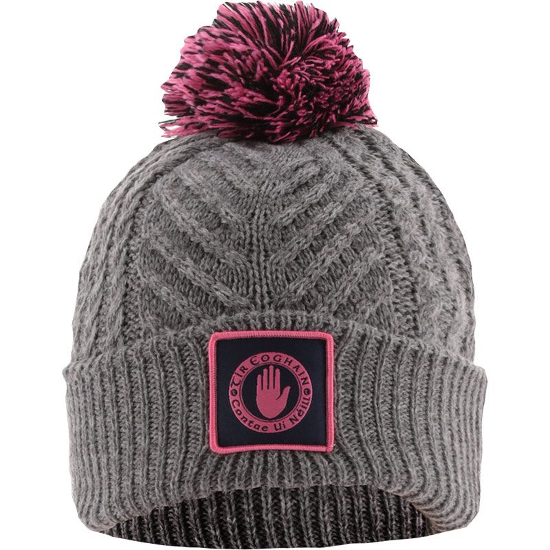 Grey and pink Tyrone GAA Ruby Bobble Hat Grey with county crest by O’Neills.
