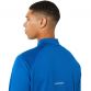 blue ASICS men's running half zip top with reflective branding from O'Neills.