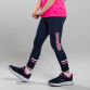 Navy girls’ 7/8 sports leggings with pink O’Neills branding on the left leg. 
