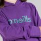 Purple girls fleece pullover hoodie with paint splatter design printed hood lining by O’Neills.