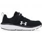 black and white Under Armour kids' runners with a hook and loop strap from O'Neills