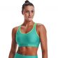 Women's Green Under Armour Mid Sports Bra, with racer back design for enhanced range of motion from O'Neills.