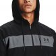 Black Under Armour men's hooded windbreaker jacket with zip pockets from O'Neills.