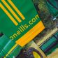 Green and Yellow Men's O’Neills ploughing jersey with an image of a green combine harvester on the front and “Green Roots” printed on the back.