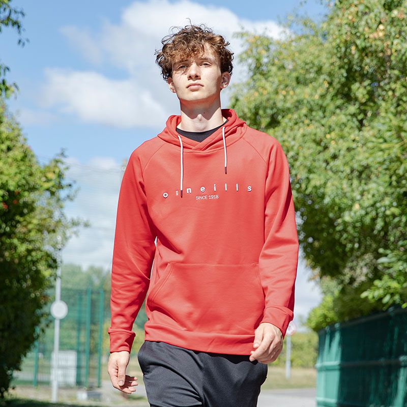 Red Men’s Fleece Pullover Hoodie with front pouch pocket and embroidered O’Neills branding on the chest on model.
