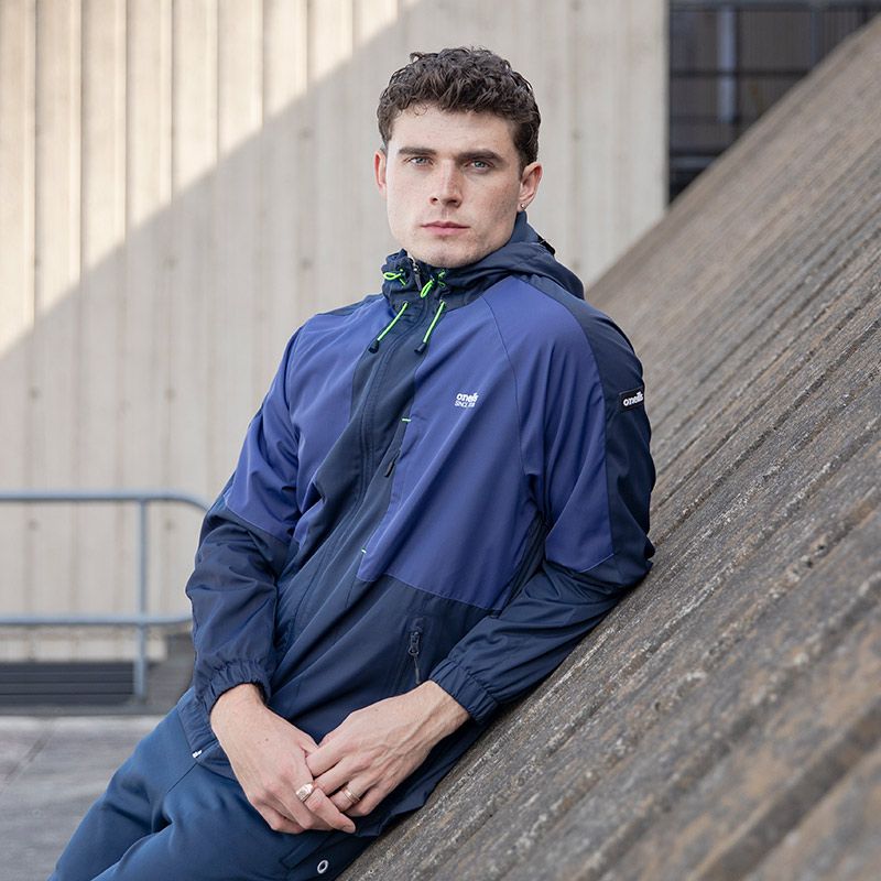 Men's Marine and Green Rio rain jacket with hood and zip from O'Neills model image.