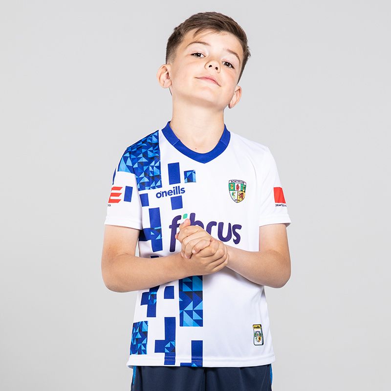White and Royal Antrim GAA Kids' Short Sleeve Training Top from ONeills.