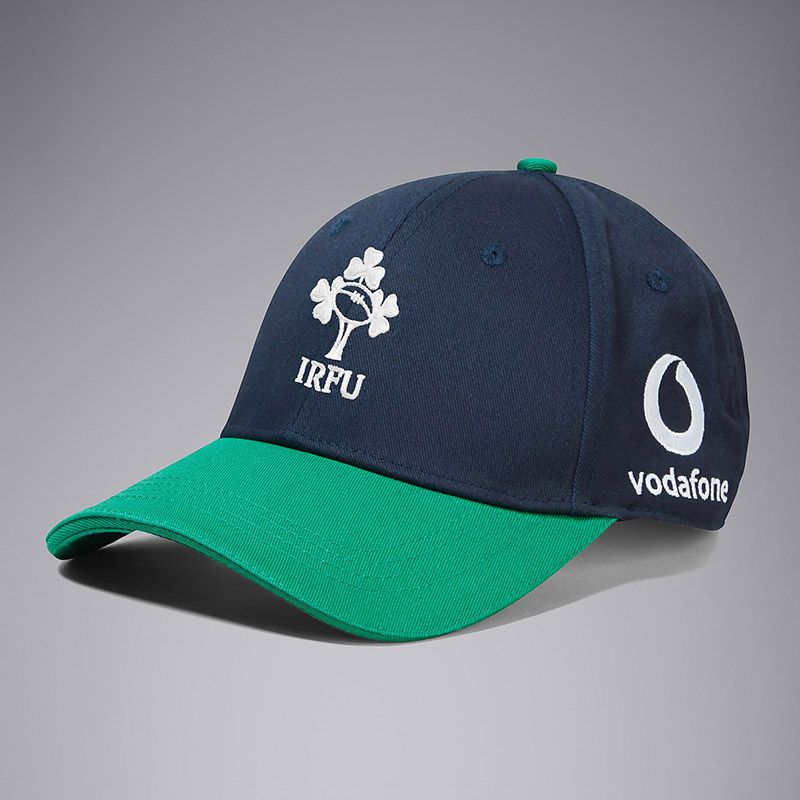 Navy and Green Canterbury IRFU Cap with white team branding and sponsor logo from O'Neills